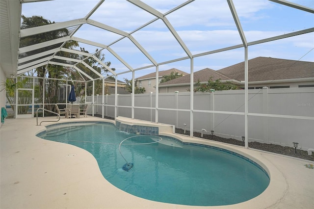 view of pool with a patio and glass enclosure