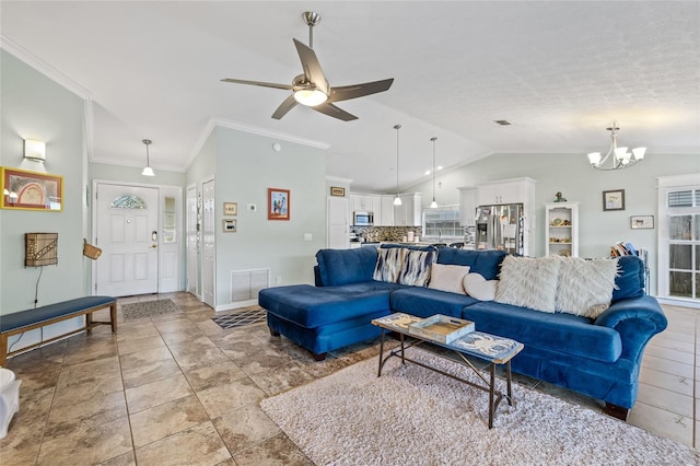 living room featuring ornamental molding, ceiling fan with notable chandelier, and lofted ceiling