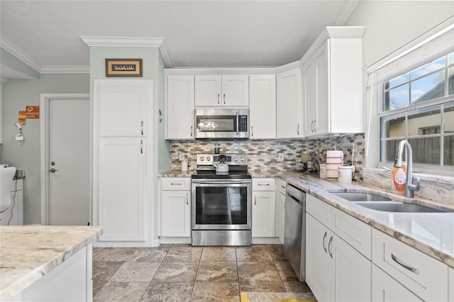 kitchen featuring sink, white cabinetry, stainless steel appliances, and ornamental molding