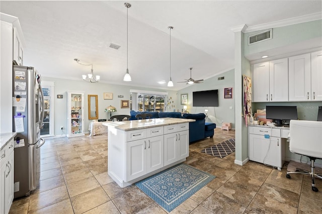 kitchen featuring lofted ceiling, ceiling fan with notable chandelier, hanging light fixtures, white cabinetry, and stainless steel refrigerator