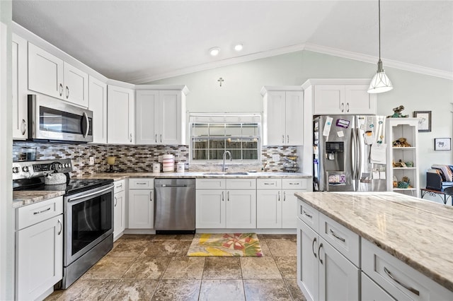 kitchen featuring backsplash, stainless steel appliances, vaulted ceiling, sink, and white cabinets