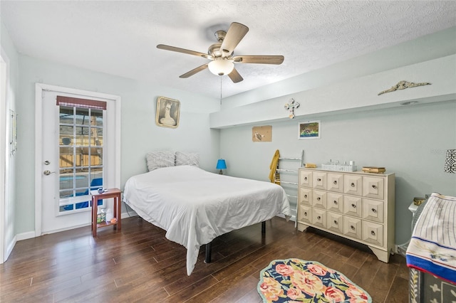 bedroom featuring a textured ceiling, dark hardwood / wood-style flooring, and ceiling fan