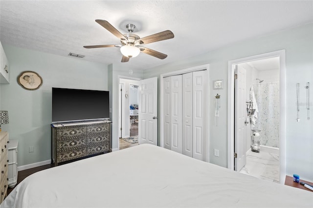 bedroom featuring ceiling fan, a closet, a textured ceiling, and ensuite bath