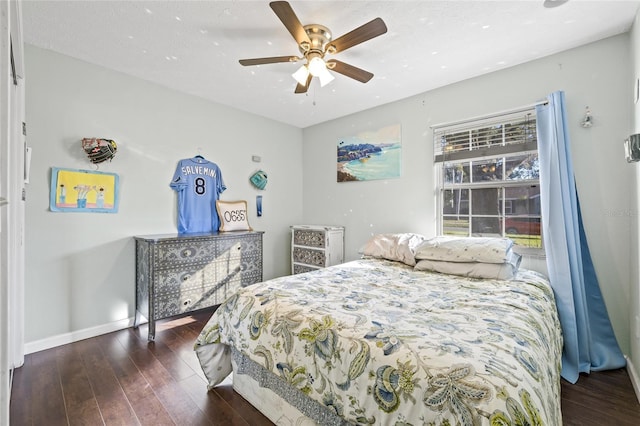 bedroom with ceiling fan and dark wood-type flooring