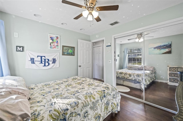 bedroom with a closet, ceiling fan, and dark wood-type flooring