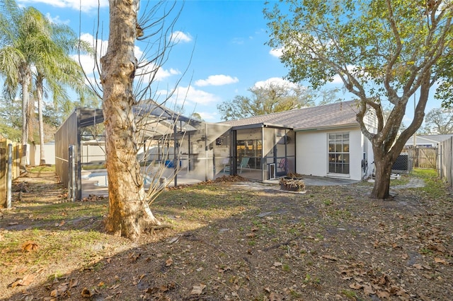 rear view of property with glass enclosure