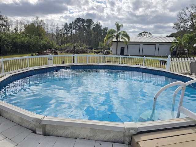 view of swimming pool with an outdoor structure