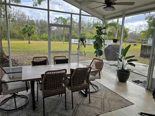 sunroom / solarium featuring ceiling fan