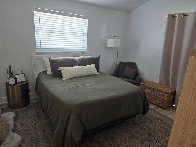 bedroom with hardwood / wood-style floors