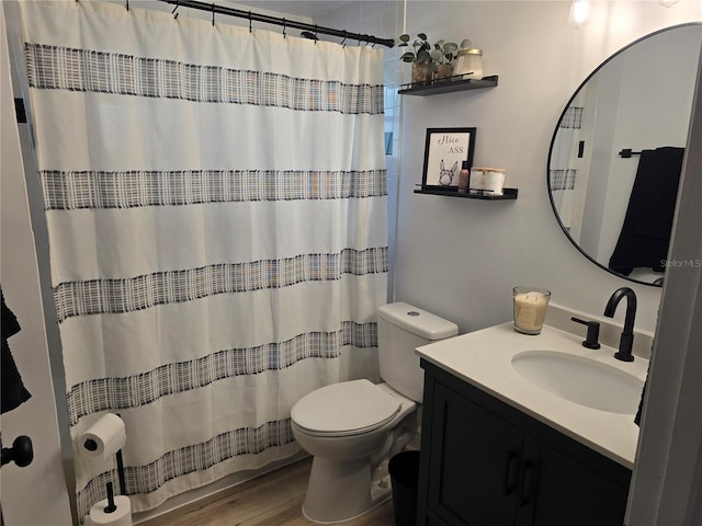 bathroom featuring hardwood / wood-style floors, vanity, toilet, and a shower with shower curtain