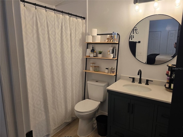 bathroom featuring hardwood / wood-style flooring, vanity, and toilet