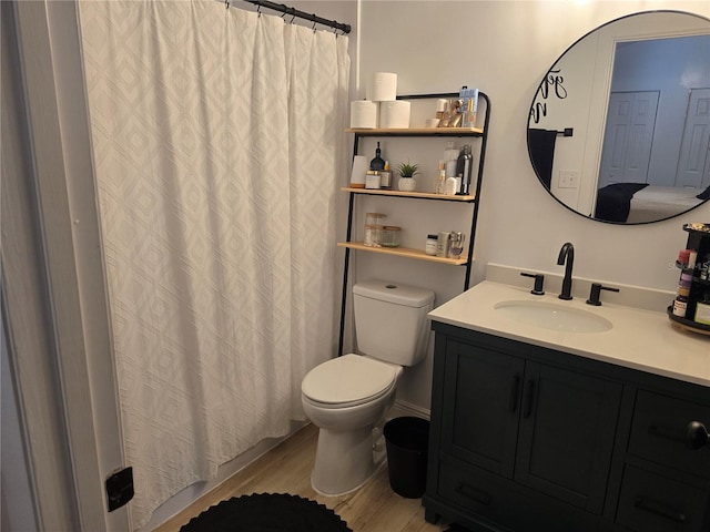 bathroom featuring hardwood / wood-style flooring, vanity, and toilet