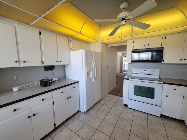 kitchen with white appliances, ceiling fan, light tile patterned floors, and white cabinets