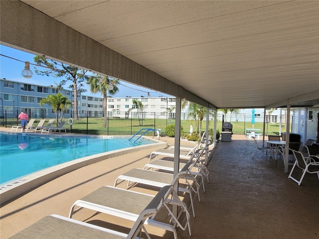 view of swimming pool featuring a patio and a lawn