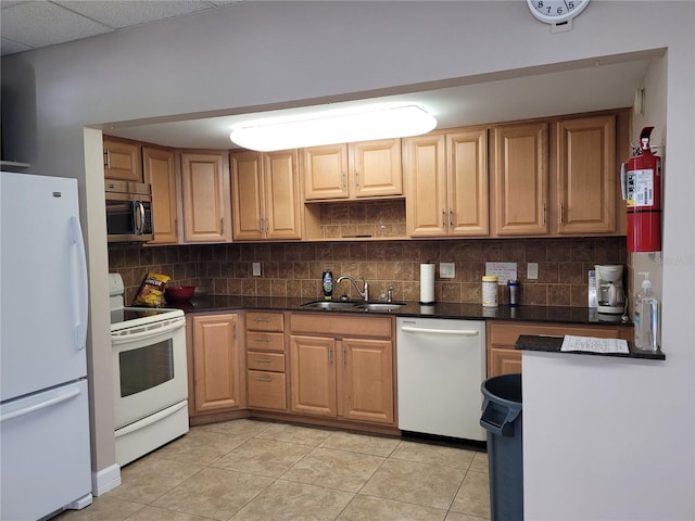 kitchen with sink, light tile patterned floors, backsplash, and white appliances