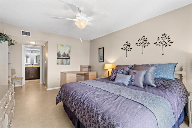 bedroom with ceiling fan, light tile patterned floors, and ensuite bathroom