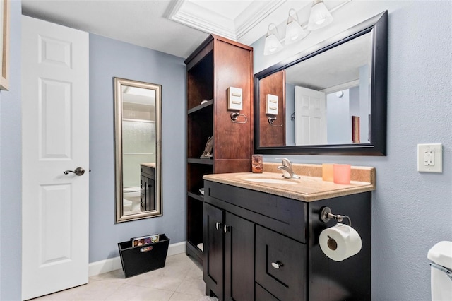 bathroom featuring tile patterned flooring, vanity, toilet, and crown molding