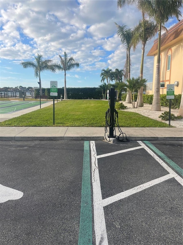 view of car parking with a yard