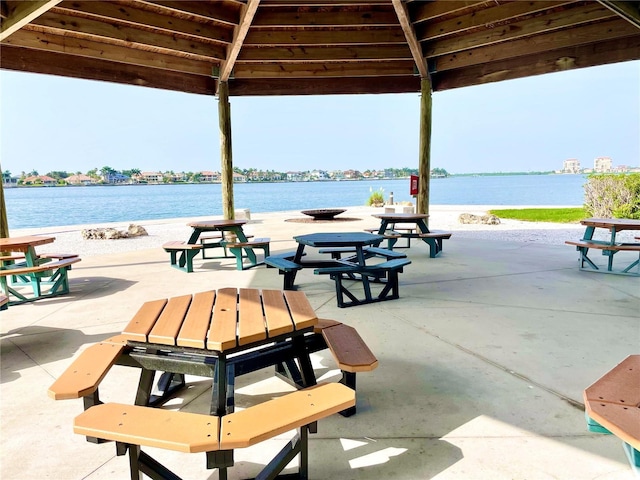 surrounding community featuring a gazebo, a patio, and a water view