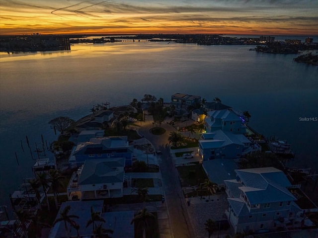 aerial view at dusk with a water view