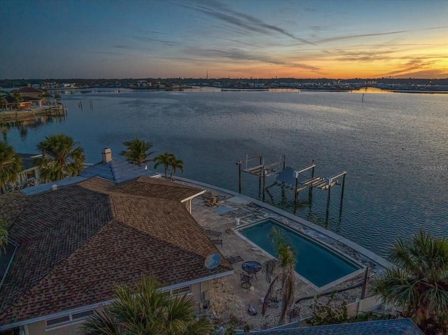 aerial view at dusk with a water view