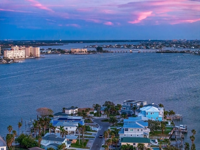 aerial view at dusk with a water view