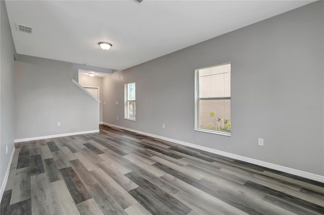 unfurnished room with plenty of natural light and wood-type flooring