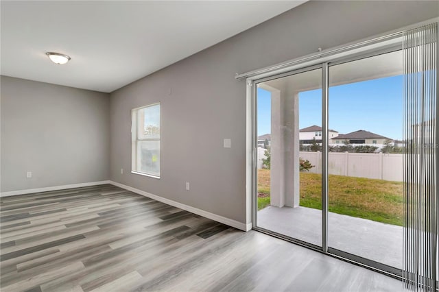 unfurnished room with hardwood / wood-style flooring