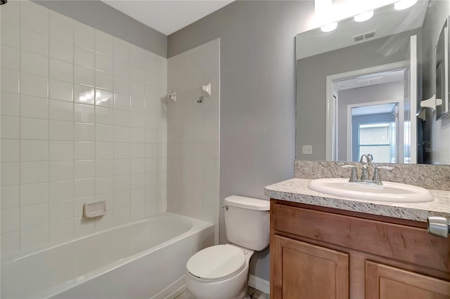 full bathroom with vanity, toilet, and tiled shower / bath combo