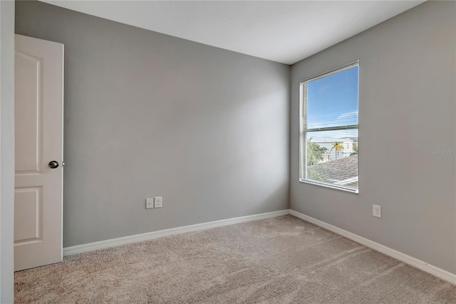 unfurnished room featuring light carpet