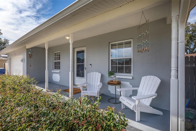 exterior space with a porch and a garage