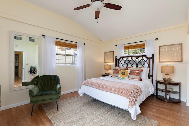 bedroom with ceiling fan, vaulted ceiling, and hardwood / wood-style flooring