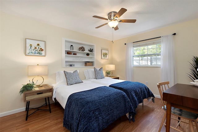 bedroom with ceiling fan and hardwood / wood-style flooring