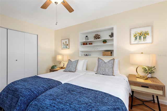 bedroom with hardwood / wood-style floors, ceiling fan, and a closet