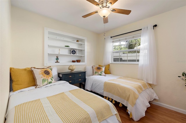 bedroom with ceiling fan and wood-type flooring