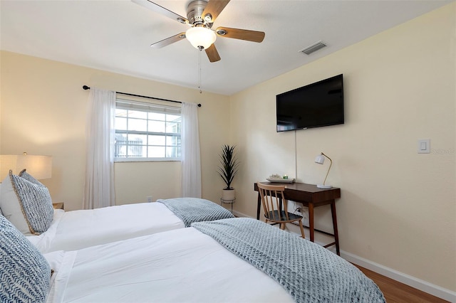 bedroom with ceiling fan and hardwood / wood-style floors