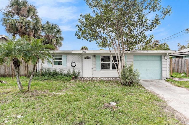 single story home featuring a front yard and a garage