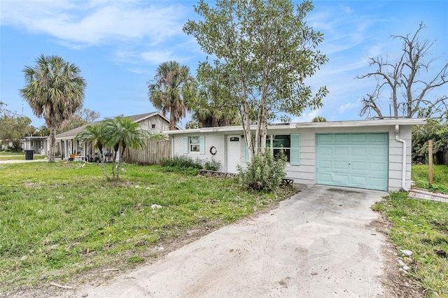 ranch-style home with a front lawn and a garage