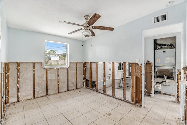 spare room featuring ceiling fan and heating unit