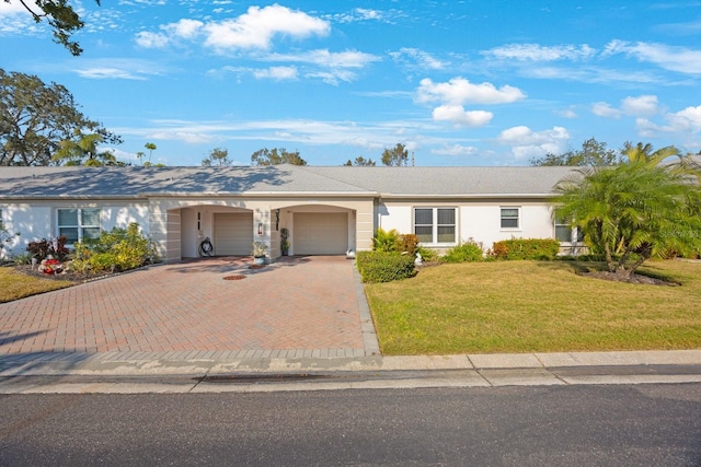 single story home with a front yard and a garage