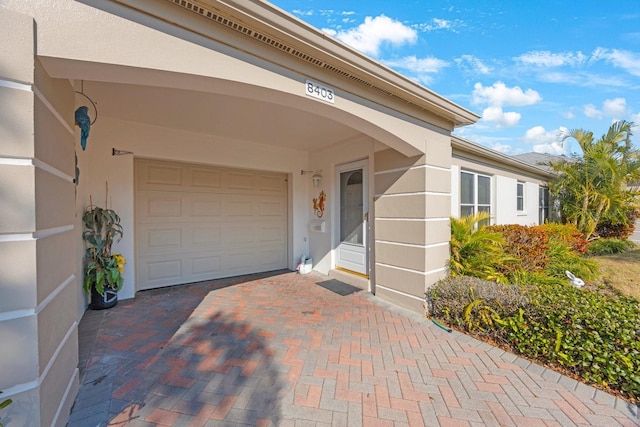 doorway to property with a garage