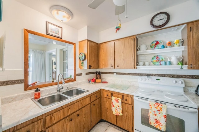 kitchen with white electric stove, ceiling fan, decorative backsplash, sink, and light tile patterned flooring