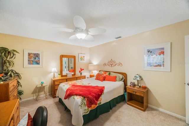 bedroom with ceiling fan and light colored carpet