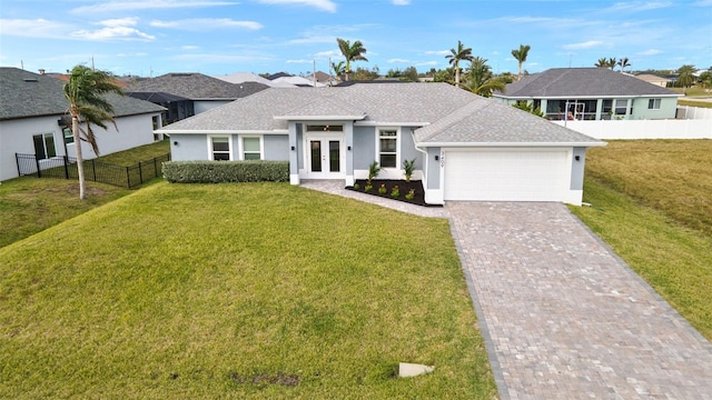 view of front of property featuring french doors, a front lawn, and a garage