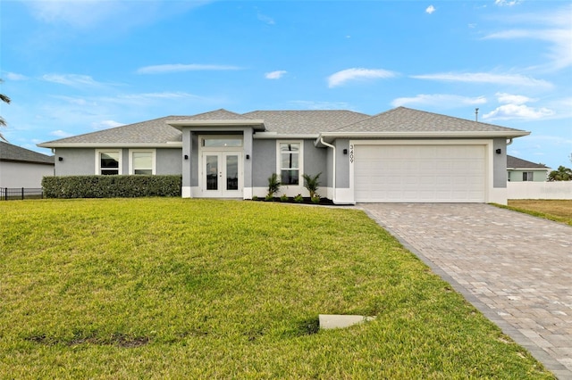 view of front facade with french doors, a front yard, and a garage