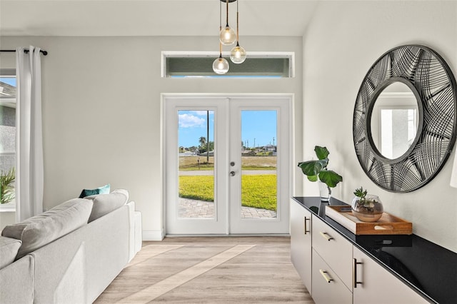 entryway with light hardwood / wood-style flooring and french doors