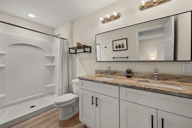 bathroom featuring toilet, hardwood / wood-style floors, vanity, and a shower with shower curtain