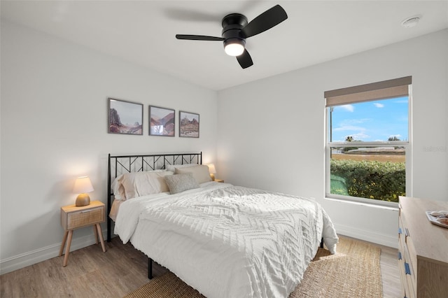 bedroom with hardwood / wood-style flooring and ceiling fan