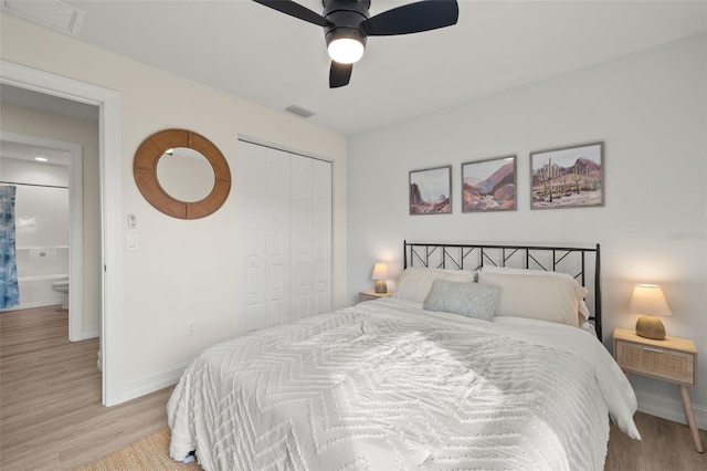 bedroom featuring ceiling fan, a closet, and light wood-type flooring