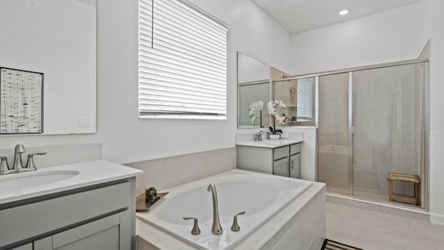 bathroom featuring tile patterned floors, vanity, a healthy amount of sunlight, and plus walk in shower